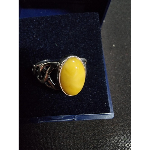 248 - 925 silver ring inset with a large oval genuine  butterscotch amber stone in good clean condition si... 