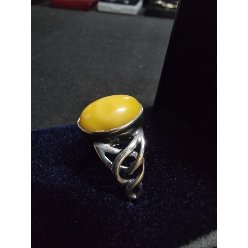 248 - 925 silver ring inset with a large oval genuine  butterscotch amber stone in good clean condition si... 