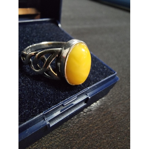 248 - 925 silver ring inset with a large oval genuine  butterscotch amber stone in good clean condition si... 