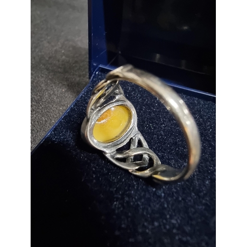 248 - 925 silver ring inset with a large oval genuine  butterscotch amber stone in good clean condition si... 