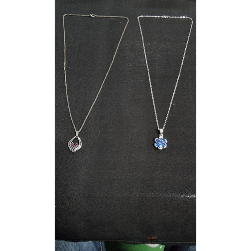 283 - 2 x 925 silver pendant and chains both on 925 silver chains inset with three genuine ruby stones the... 