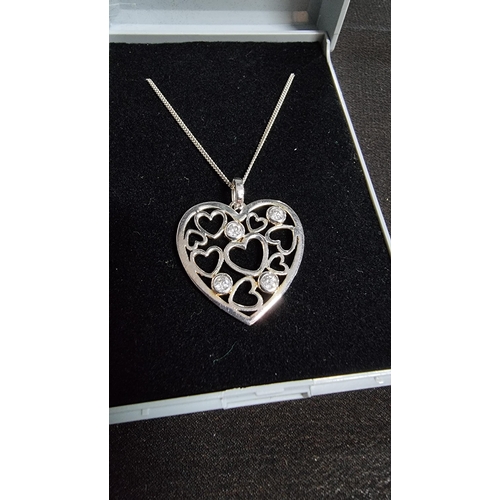 288 - 925 silver heart pendnat with 4 cz stones set on an 18 in 925 silver chain in good condition