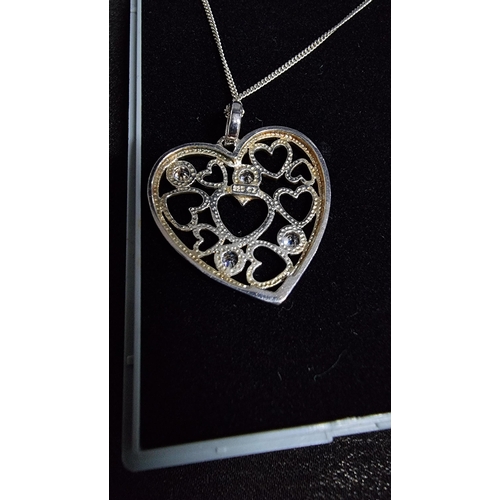 288 - 925 silver heart pendnat with 4 cz stones set on an 18 in 925 silver chain in good condition