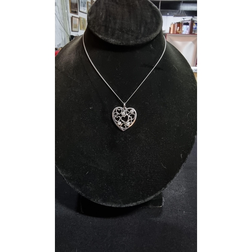 288 - 925 silver heart pendnat with 4 cz stones set on an 18 in 925 silver chain in good condition