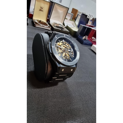 294 - Attractive Ralph Christian gents black automatic  watch with a brass skeleton dial on a metal link b... 