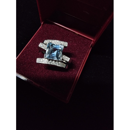 298 - Good chunky 18ct white gold ring inset with a large square cushion cut aqua marine stone to the cent... 