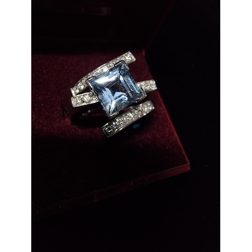 298 - Good chunky 18ct white gold ring inset with a large square cushion cut aqua marine stone to the cent... 