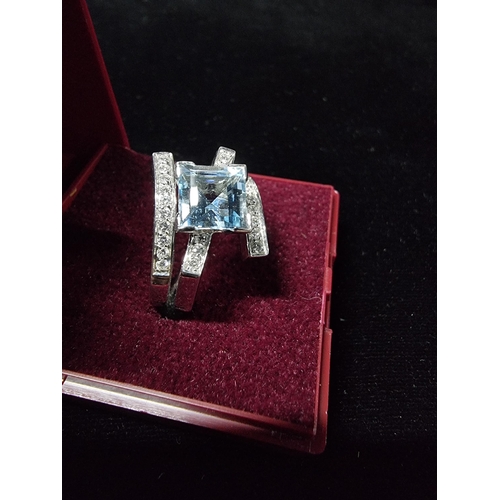 298 - Good chunky 18ct white gold ring inset with a large square cushion cut aqua marine stone to the cent... 