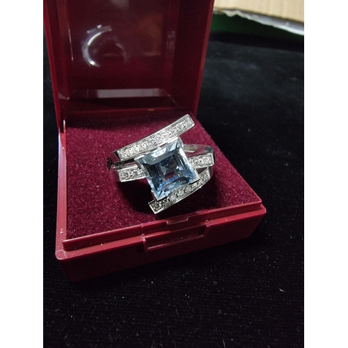 298 - Good chunky 18ct white gold ring inset with a large square cushion cut aqua marine stone to the cent... 