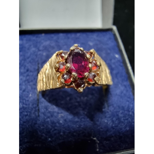 303 - 9ct Garnet cluster ring Size S 1/2 with bark effect ring band. total weight of 3.9 grams