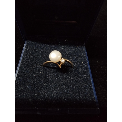 304 - 9ct gold ring inset with a pearl and diamond AF missing the mount on the one side for a small dimond... 