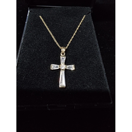 306 - 9ct gold crucifix pendant with clear crystal glass stones set on a 17in 9ct gold chain chain is mark... 