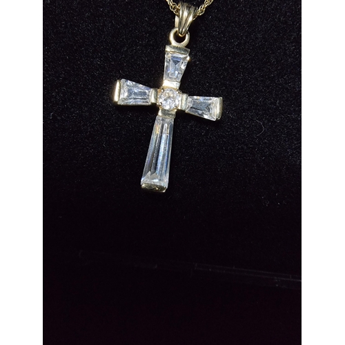 306 - 9ct gold crucifix pendant with clear crystal glass stones set on a 17in 9ct gold chain chain is mark... 