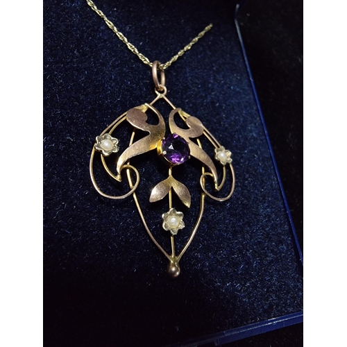 311 - Pretty vintage 9ct gold pendant inset with a large amethyst to the centre and 3 small split seed pea... 