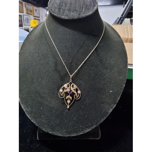 311 - Pretty vintage 9ct gold pendant inset with a large amethyst to the centre and 3 small split seed pea... 