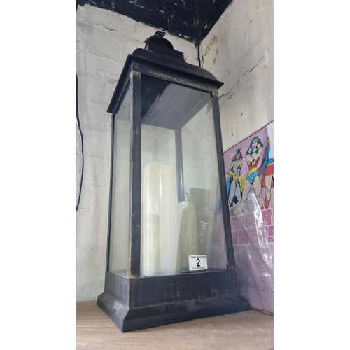 2 - Tall modern lantern with three battery powered candles  inside measures 70cm high