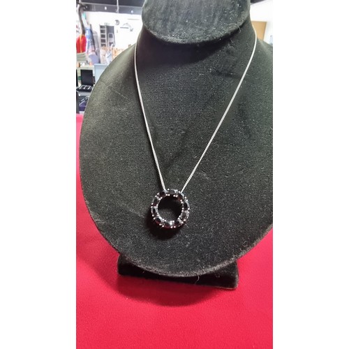 145 - 925 silver pendant inset with black tourmaline stones on a 16 inch 925 silver chain