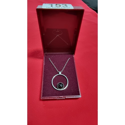 153 - White metal pendant and 16 inch chain with a black stone marked GEM