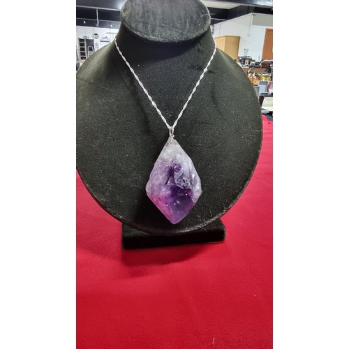 176 - Very large and chunky pointed Amethyst pendant presenting very good deep purple to white colours set... 