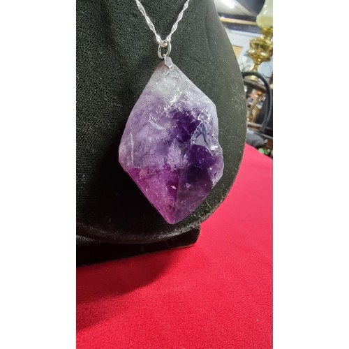 176 - Very large and chunky pointed Amethyst pendant presenting very good deep purple to white colours set... 