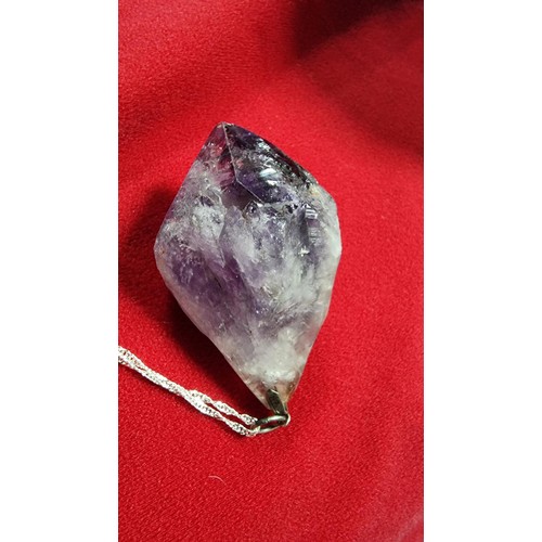 176 - Very large and chunky pointed Amethyst pendant presenting very good deep purple to white colours set... 