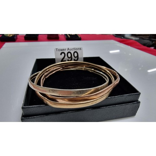 299 - 9ct. tri colour gold three piece bangle with white rose and yellow golds unmarked but tests as 9ct. ... 