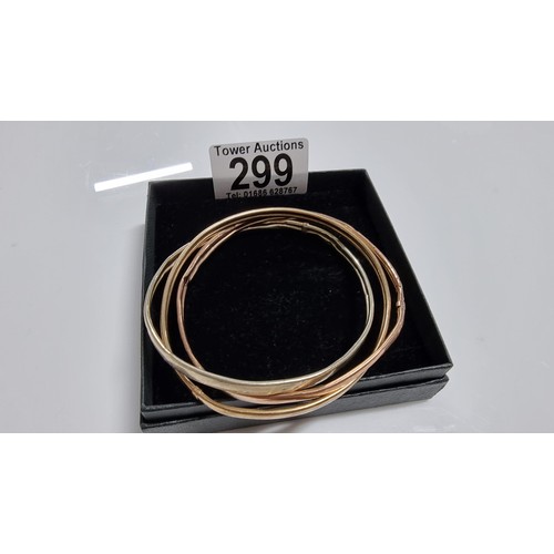 299 - 9ct. tri colour gold three piece bangle with white rose and yellow golds unmarked but tests as 9ct. ... 