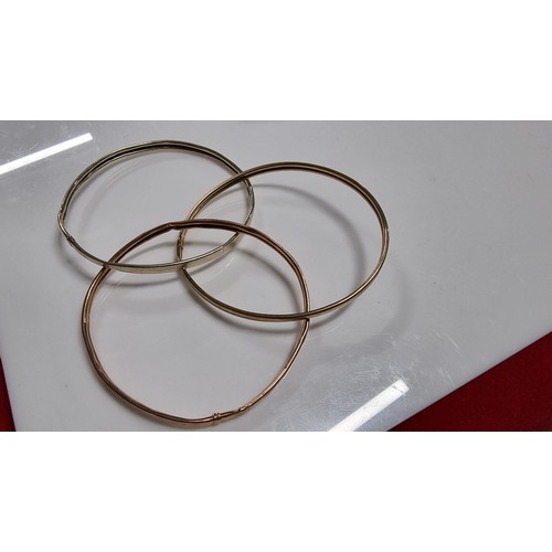 299 - 9ct. tri colour gold three piece bangle with white rose and yellow golds unmarked but tests as 9ct. ... 
