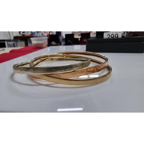 299 - 9ct. tri colour gold three piece bangle with white rose and yellow golds unmarked but tests as 9ct. ... 