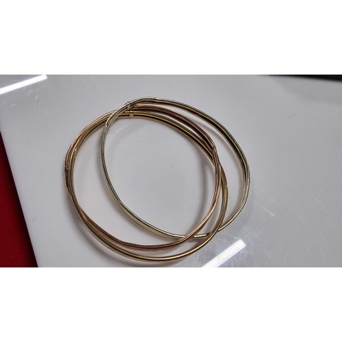 299 - 9ct. tri colour gold three piece bangle with white rose and yellow golds unmarked but tests as 9ct. ... 