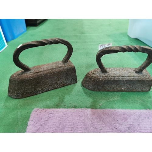 220 - 2x very heavy cast iron iron formed door stops. Height of 18cm x length 26cm