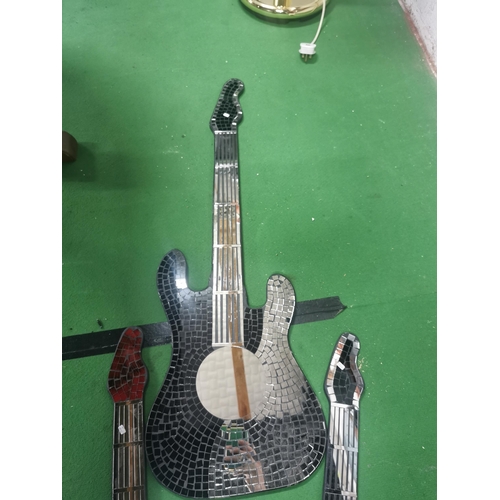 235 - 3 guitar shaped mirror's with a mosiac design. Tallest guitar measures 103cm.