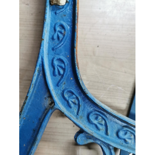 59 - Pair of blue cast iron bench ends with a heart decoration to the center panel. Height of 74cm