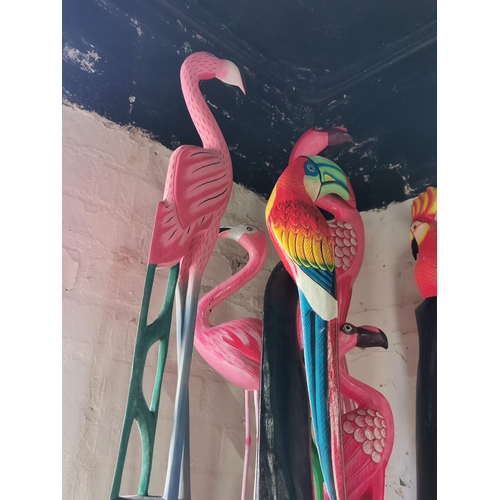 69 - Quantity of wooden items inc flamingos and toucans etc. Tallest piece measures 98cm