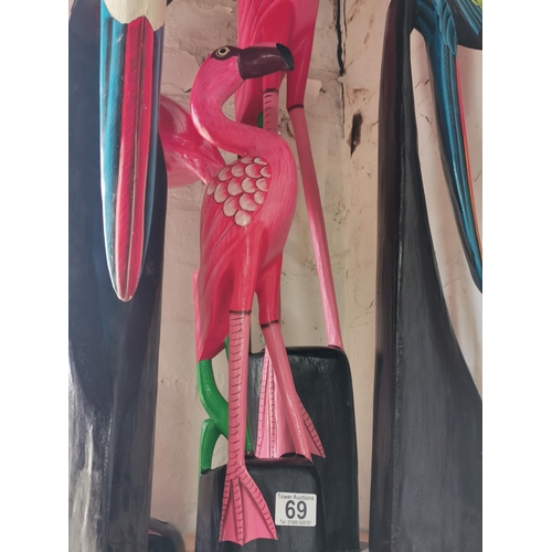 69 - Quantity of wooden items inc flamingos and toucans etc. Tallest piece measures 98cm