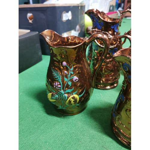 157 - Quantity of 9x copper lustre ware jugs, 6 have handpainted floral design with a Lozenge shaped date ... 