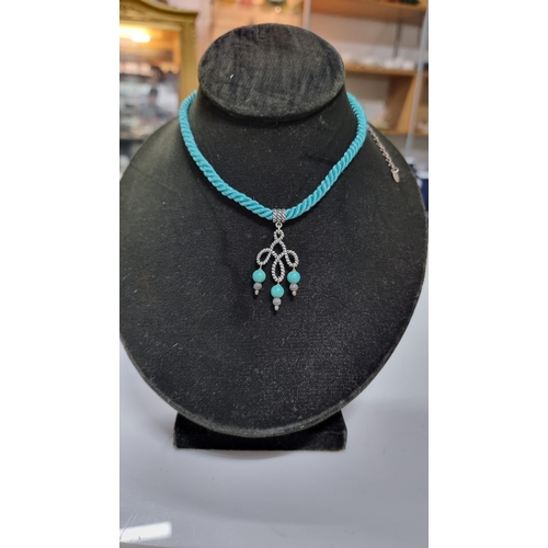 271 - 925 silver pendant with Turquoise bead drops on blue rope cord. With silver mounts & clasp to the en... 