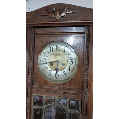 67 - Antique solid oak wall clock with a bevel edged glass door front in good condition striking on a gon... 