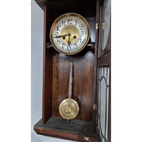 67 - Antique solid oak wall clock with a bevel edged glass door front in good condition striking on a gon... 