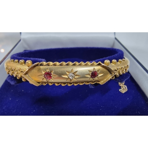 310 - Vintage hallmarked 9ct yellow gold oval hinge bangle, with ornate design inset with 2 genuine Ruby s... 