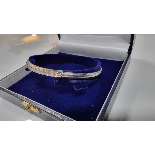 312 - 9ct White Gold bangle inset with a quantity of CZ white crystal stones, in excellent clean condition... 