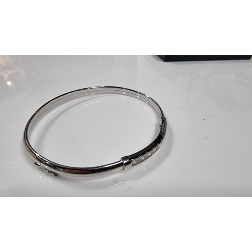 312 - 9ct White Gold bangle inset with a quantity of CZ white crystal stones, in excellent clean condition... 