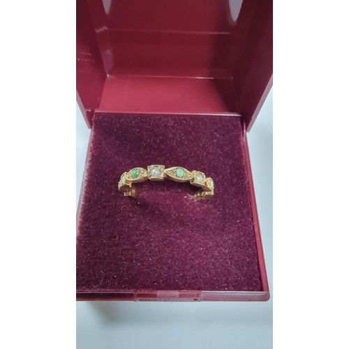 317 - Unusual hallmarked 9ct gold ring inset with small split seed pearls and green stones in good conditi... 