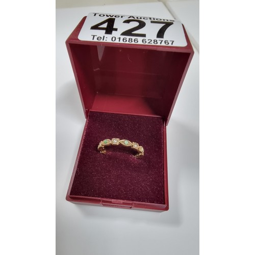 317 - Unusual hallmarked 9ct gold ring inset with small split seed pearls and green stones in good conditi... 