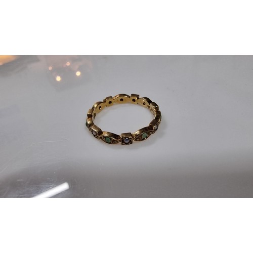 317 - Unusual hallmarked 9ct gold ring inset with small split seed pearls and green stones in good conditi... 