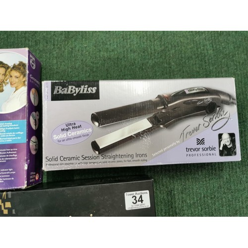 34 - Collection of 3 boxed hair stylers inc babyliss ceramic straightening tongs, GHD IV pro styler etc