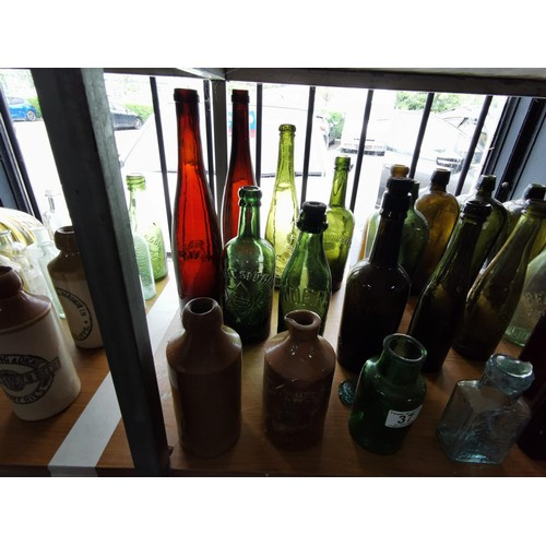 37 - Collection of approx 25 vintage coloured bottles inc beer bottles, medicine and water bottles etc