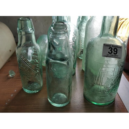 39 - Collection of 10 glass bottles inc lemonade bottles, tanners bottles along with two stoneware hot wa... 