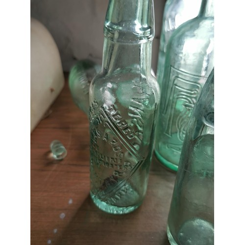 39 - Collection of 10 glass bottles inc lemonade bottles, tanners bottles along with two stoneware hot wa... 