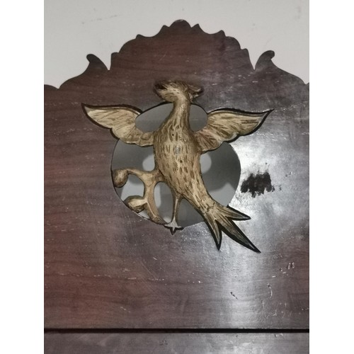 65 - Antique bevel edged mirror with ornate wooden surround and phoenix in centre, in need of restoration... 